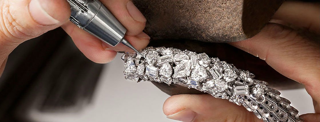 Jeweler setting diamonds in a bracelet