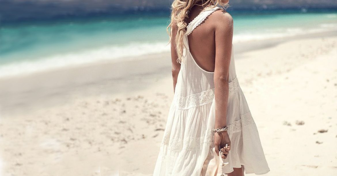 Model on beach, wearing a bracelet