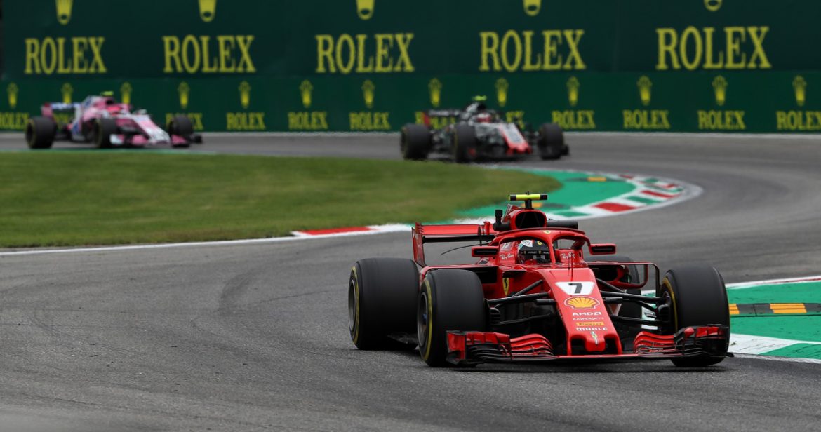 Formula 1 Race Cars with Rolex Signage in Background