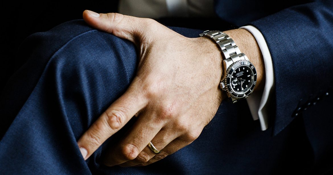 Man wearing a blue suit with a Rolex Submariner. Image via the New York Times.