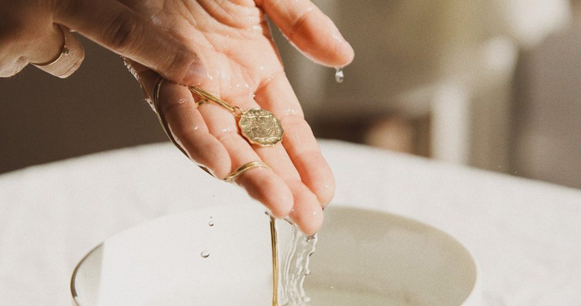 Hands cleaning jewelry. Image courtesy of Ali Heiss.